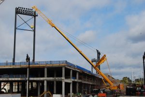 A Large Crane In Front Of A Bridge